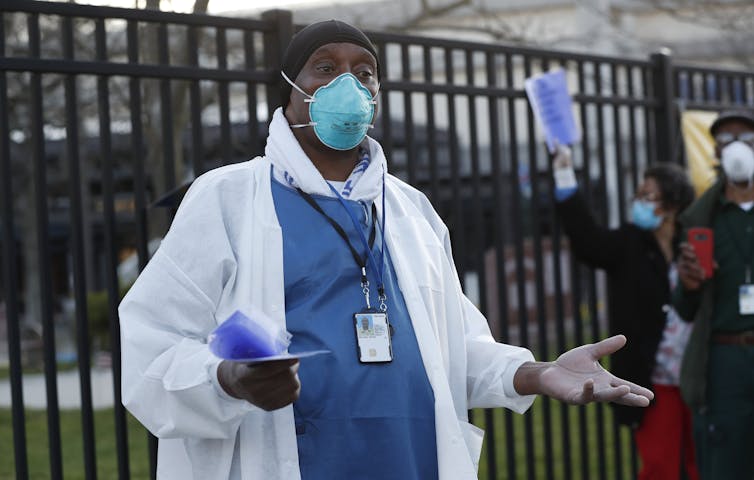 An employee of a VA hospital in Brooklyn who is outside the building at a staff protest for more protective equipment and staff assistance during the pandemic.