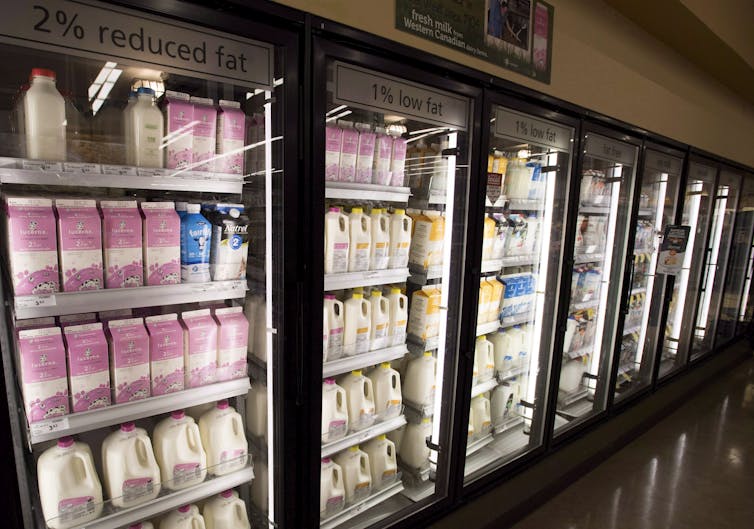 Supermarket dairy case full of milk