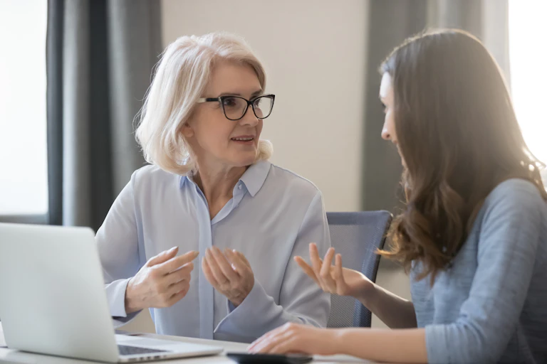 Older women giving advice to a younger woman