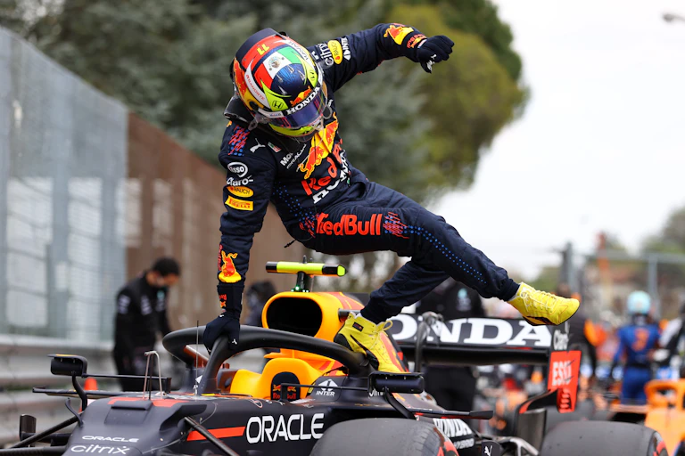 Driver jumps out of an Formula 1 car.