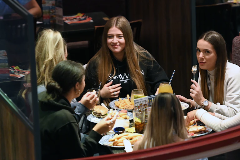 A group of friends having a meal indoors at a pub