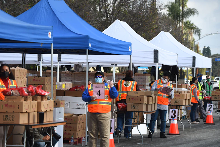 A food bank in Los Angles, distributing items to people in need outside a library.