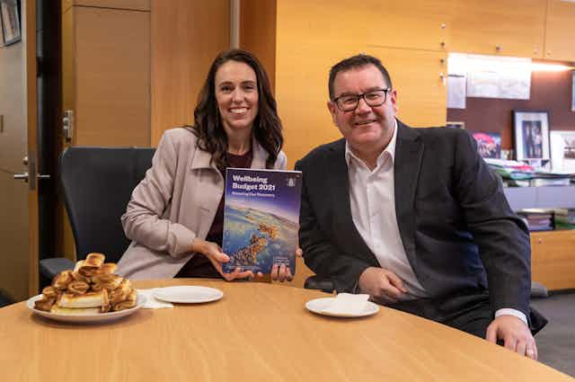 Jacinda Ardern and Grant Robertson with copy of 2021 budget