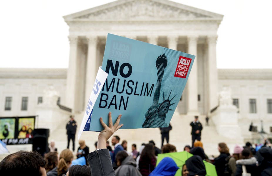 A person holds up a sign that reads "No Muslim Ban" during an anti-Muslim ban rally at the Supreme Court , Wednesday, April 25, 2018,