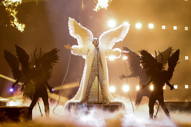 A man in a resplendent angel costume of feathers