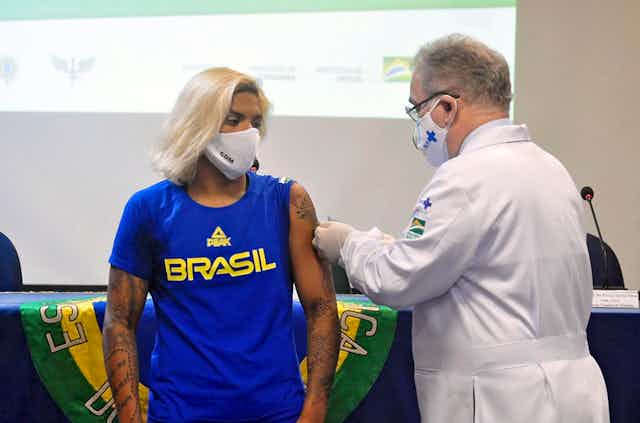 Female Brazilian athlete having COVID shot