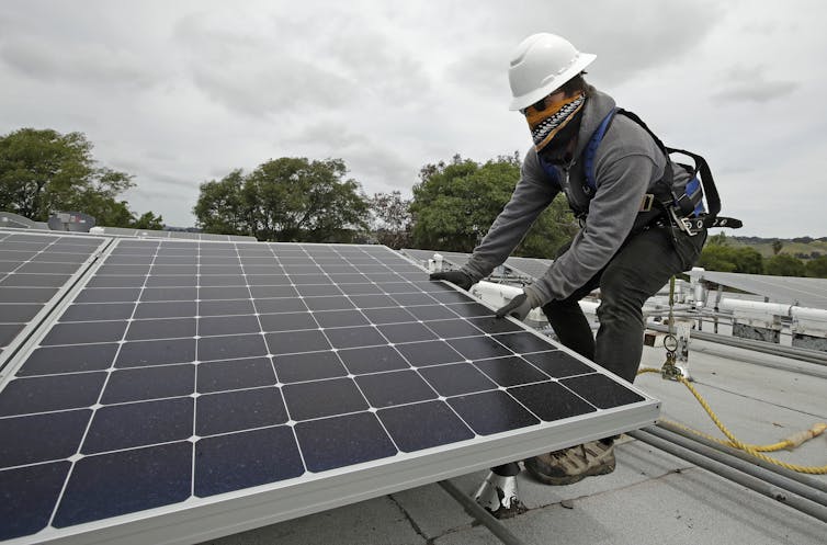 Person installing solar panel