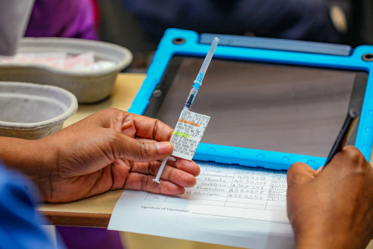 A healthworker holds a vaccine dose