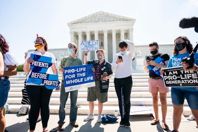 Pro-life protestors holding placards in front of the US Supreme Court Building in Washington DC, June 2020.