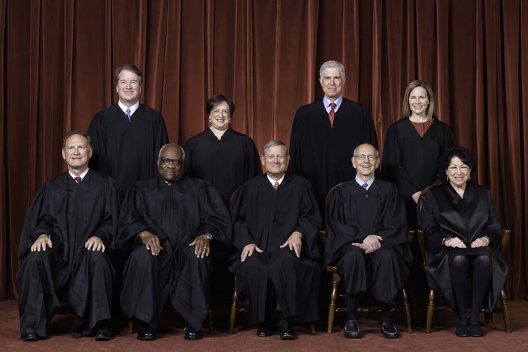 The nine members of the US Supreme Court in their robes led by Chief Justice John G. Roberts, Jr (front row, centre).:
