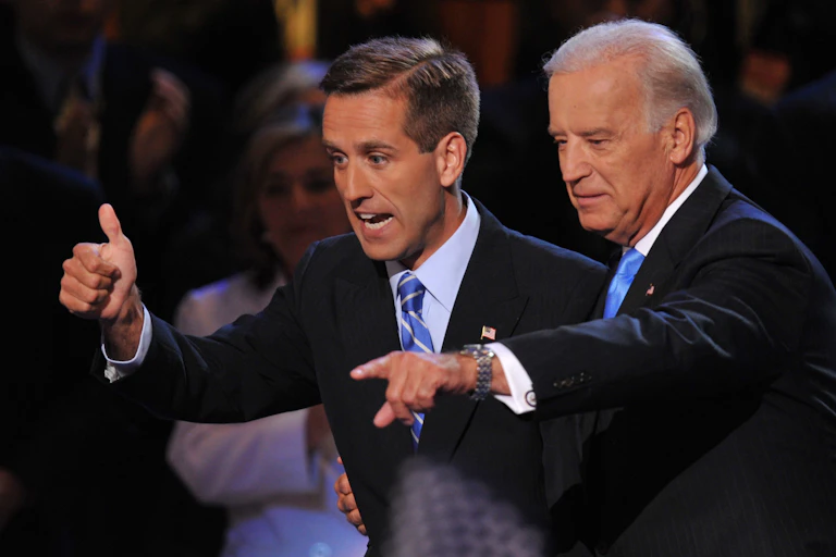 Two men gesture at a crowd