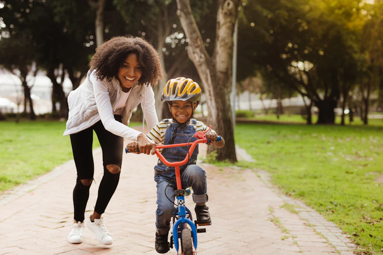 A child learning to ride a bike