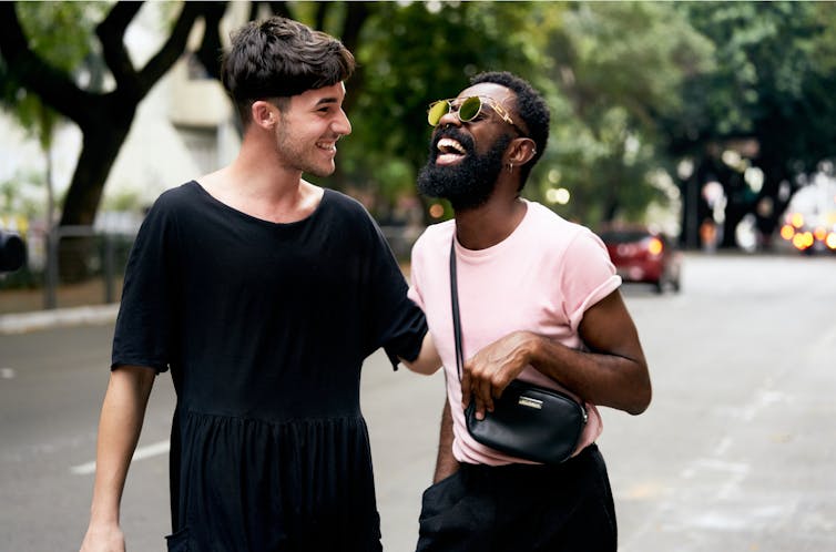 Two man laugh in the street.