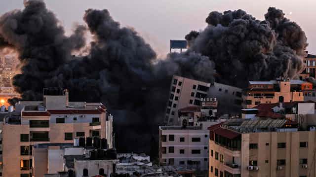 bombed buildings and black smoke in Gaza