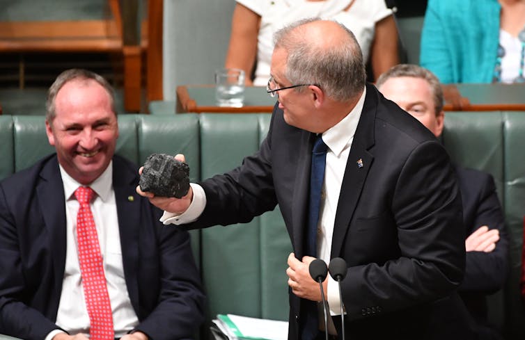 Scott Morrison holds a lump of coal next to Barnaby Joyce
