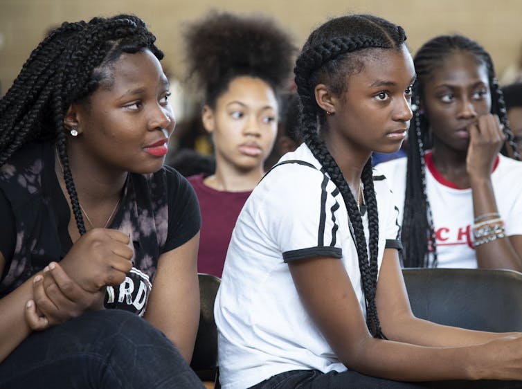 Four Black youth listen attentively