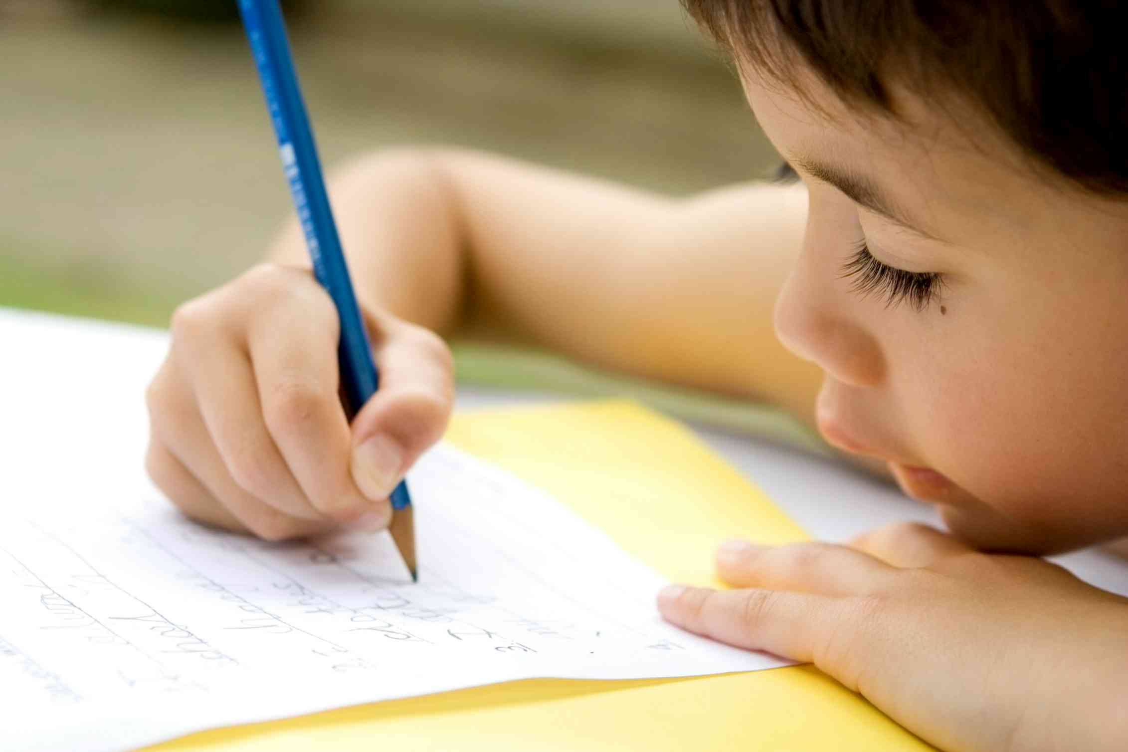 A boy holding a pencil.