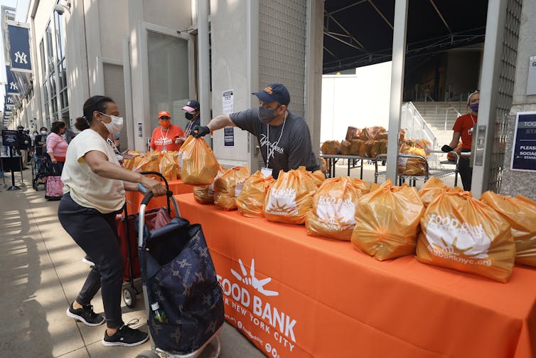 New York residents line up to receive food items at a food bank.