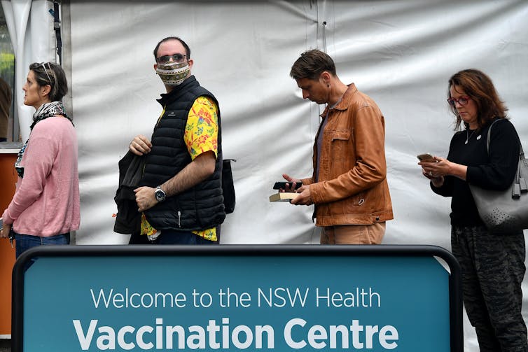 People lining up for vaccination.