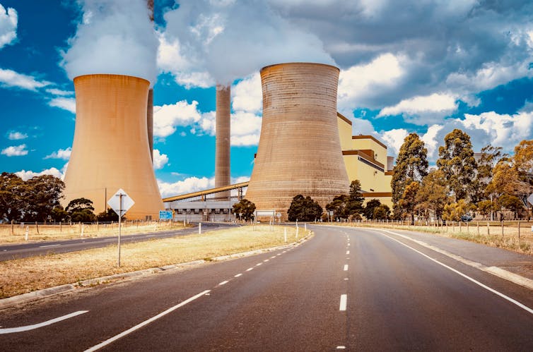 smoke billows from stacks at coal plant