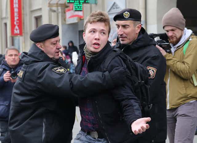 Police officers detain journalist Roman Protasevich attempting to cover a rally in Minsk, Belarus, 26 March 2017.