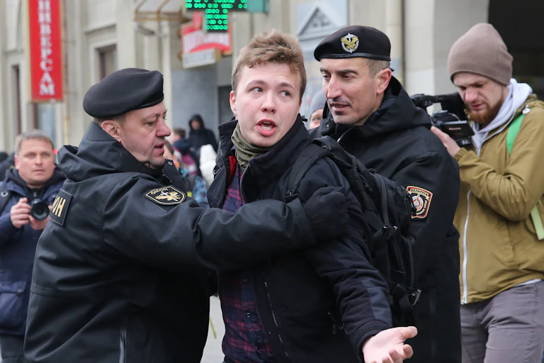 Police officers detain journalist Roman Protasevich attempting to cover a rally in Minsk, Belarus, 26 March 2017.