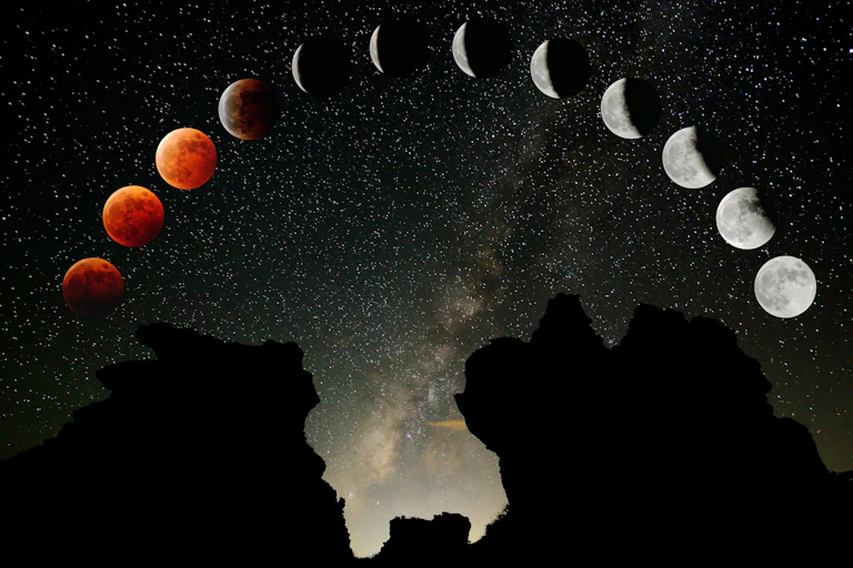 A composite image of a total lunar eclipse over a mountain.