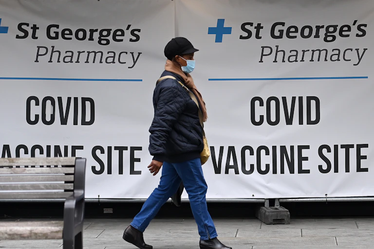 A woman leaving a COVID-19 vaccination centre