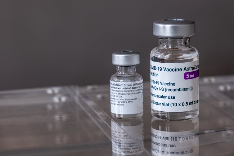 A vial of each of the AstraZeneca and Pfizer vaccines