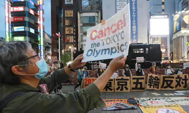 A protester objects to plans to hold the Tokyo Olympics.