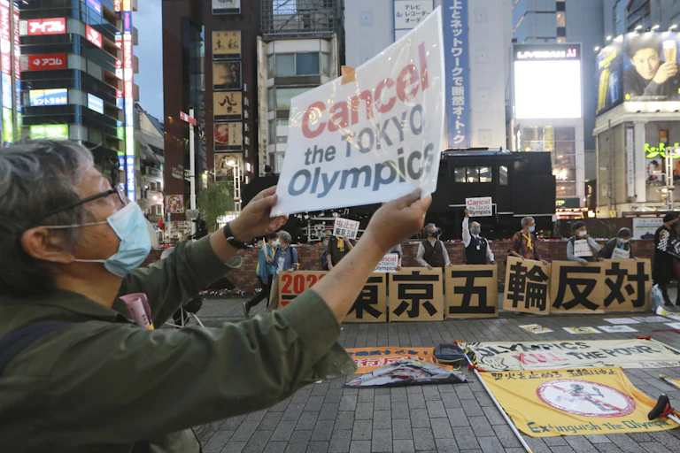A protester objects to plans to hold the Tokyo Olympics.