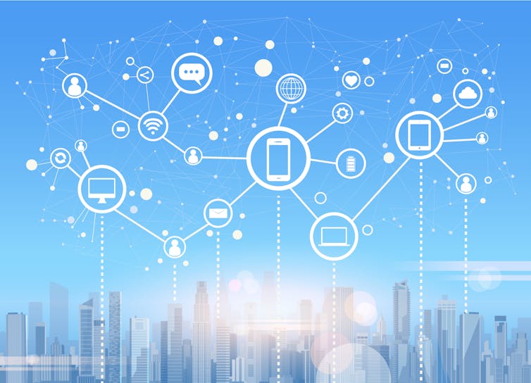 Abstract floating icons of various connected devices floating over a city scape.