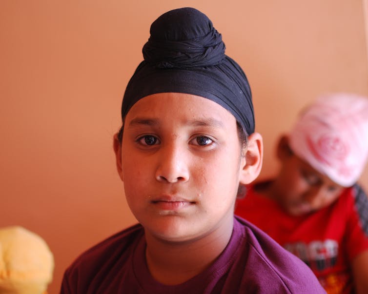 A boy wearing a patka.