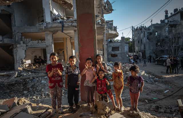 Palestinian children amid rubble from airstrikes