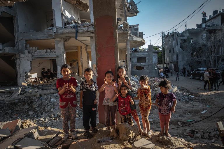 Palestinian children amid rubble from airstrikes