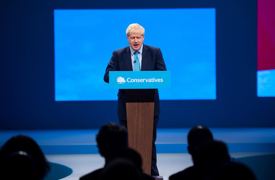 Boris Johnson at a lecturn giving a speech at the Conservative Party conference.
