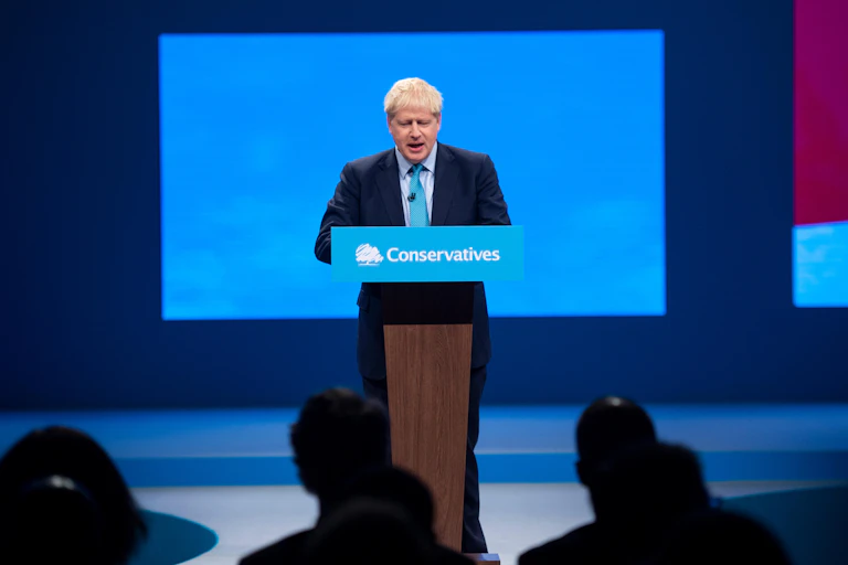 Boris Johnson at a lecturn giving a speech at the Conservative Party conference.