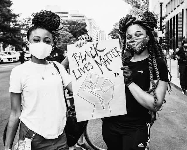 Two girls protesting the death of George Floyd in Washington June 2020.