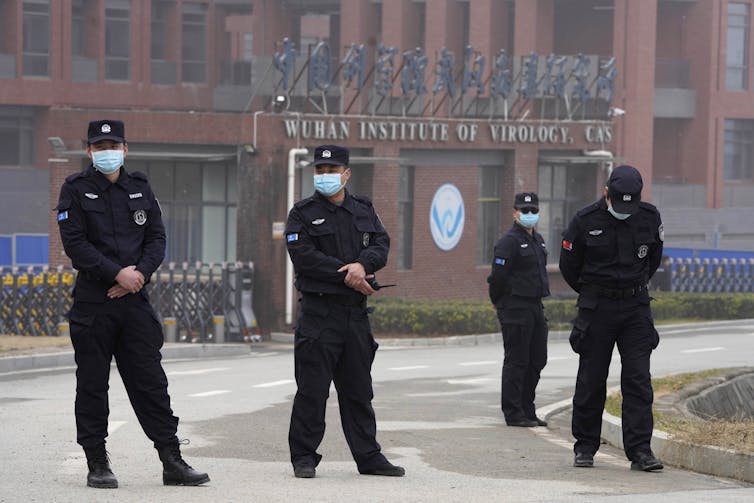 Le personnel de sécurité se rassemble près de l’entrée de l’Institut de virologie de Wuhan pendant une visite de l’équipe de l’Organisation mondiale de la santé à Wuhan, dans la province chinoise du Hubei, le 3 février 2021