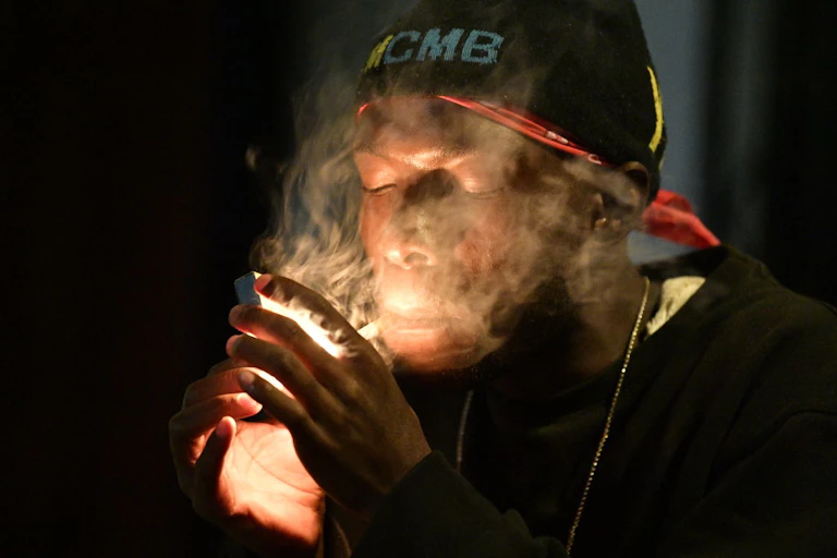 A man smokes a cigarette.