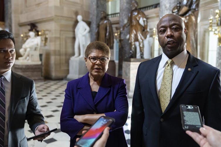 Two lawmakers, Democrat Rep. Karen Bass and GOP Sen. Tim Scott, talking with reporters after meeting on Capitol Hill to discuss police reform legislation.
