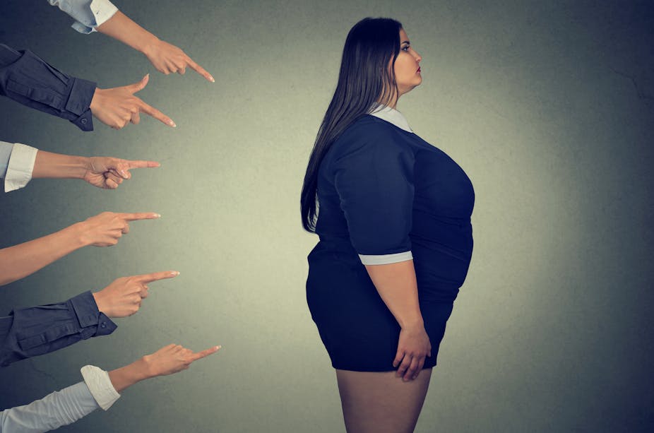 Fingers pointing at a person who is overweight.