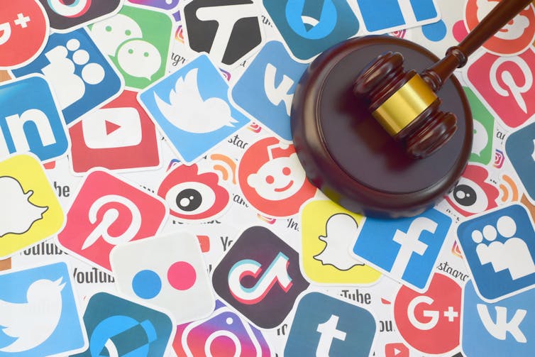 Social media logos like TikTok, Twitter, Reddit, Facebook, Instagram, Tumblr are in a collage with a judges gavel on top