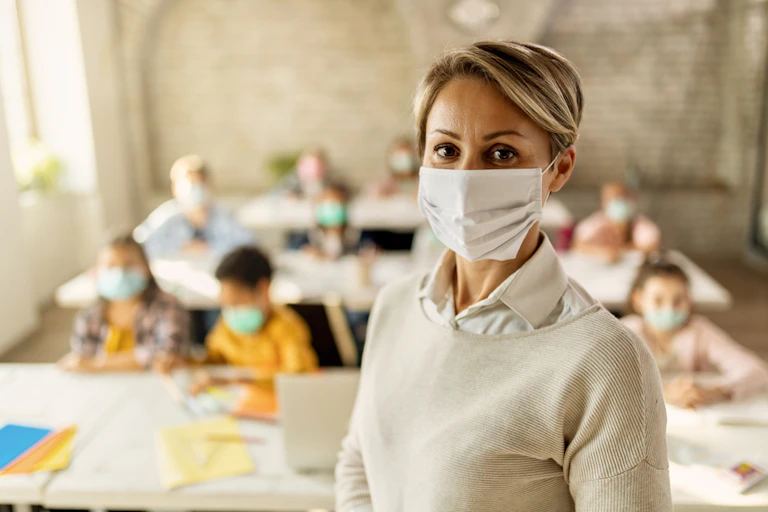 Female teacher wearing mask in class