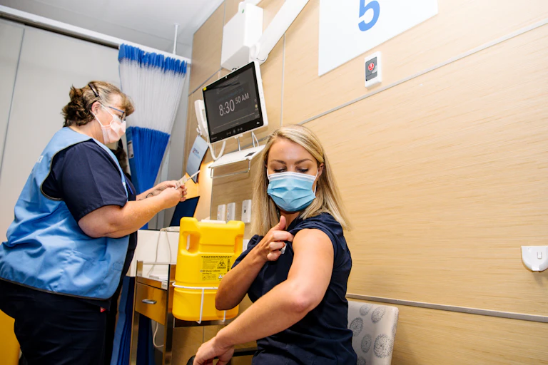 A frontline worker receives the COVID vaccine in Adelaide.