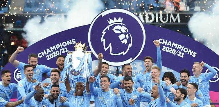 Members of Manchester City squad celebrating the Premier League title.
