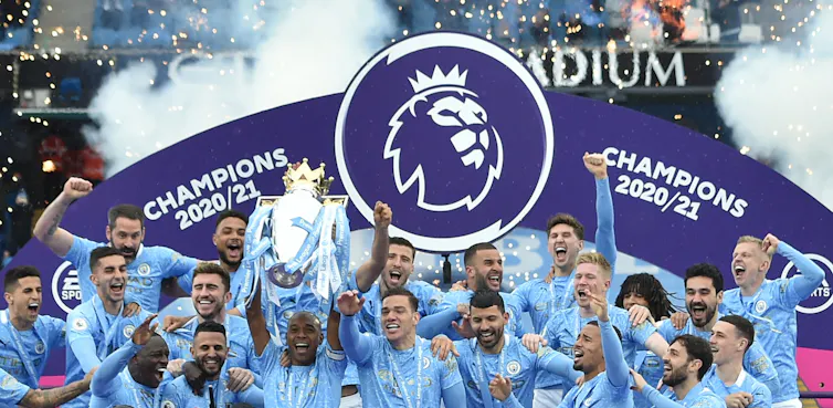 Members of Manchester City squad celebrating the Premier League title.