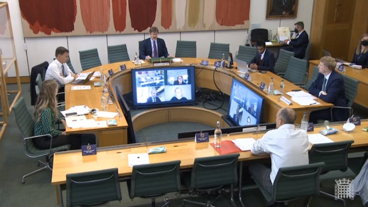 Dominic Cummings sitting in front of MPs giving evidence.