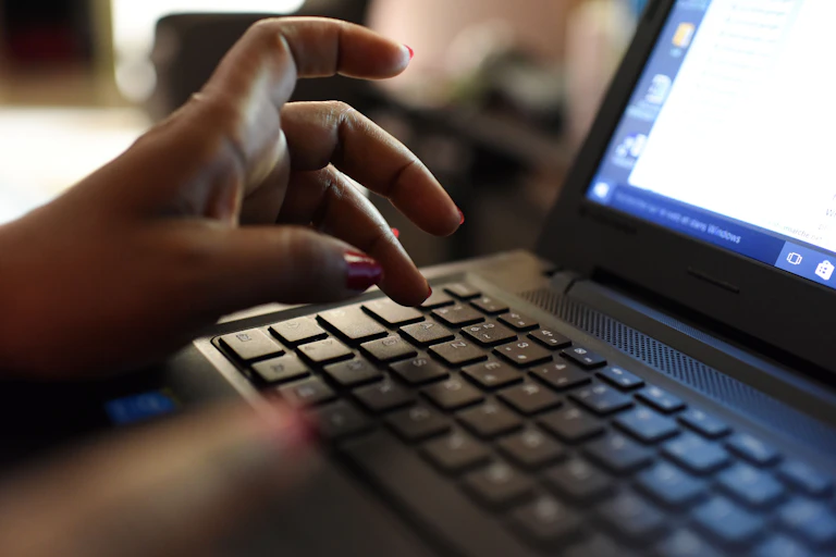 A woman typing on a computer