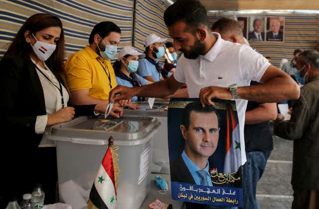  Syrian man casts his ballot in the Syrian presidential elections at a polling station set up in the Syrian embassy in the town of Yarzeh, eastern Beirut, Lebanon, May 20 2021.